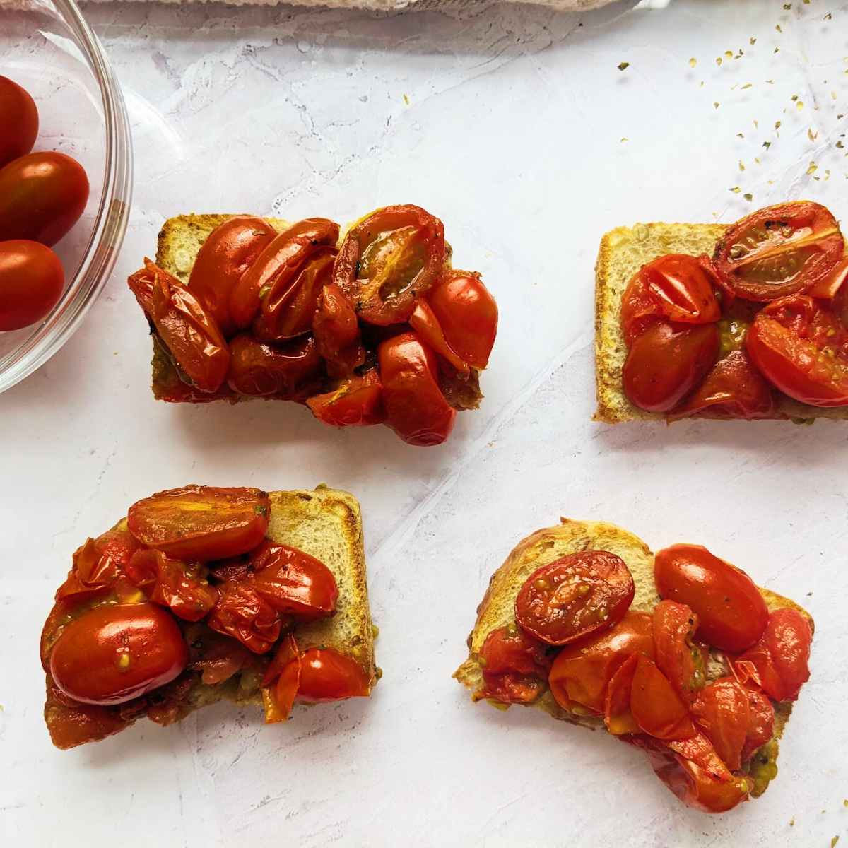 Roasted tomato halves on slices of sourdough toast