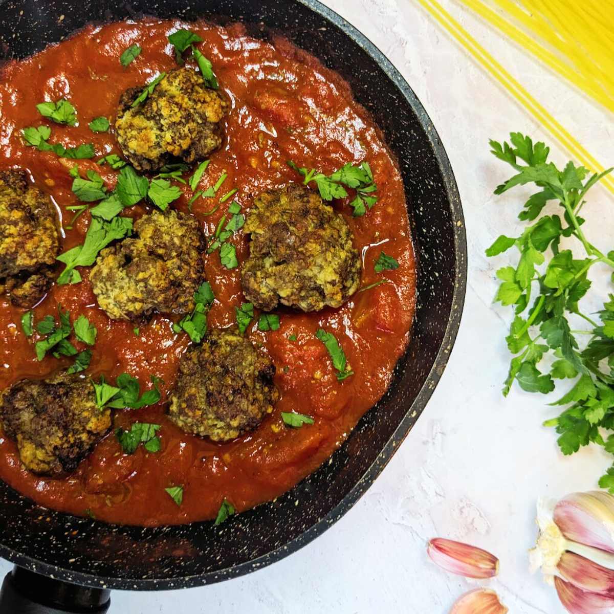 A pan of tomato sauce with six meatballs sat on top.
