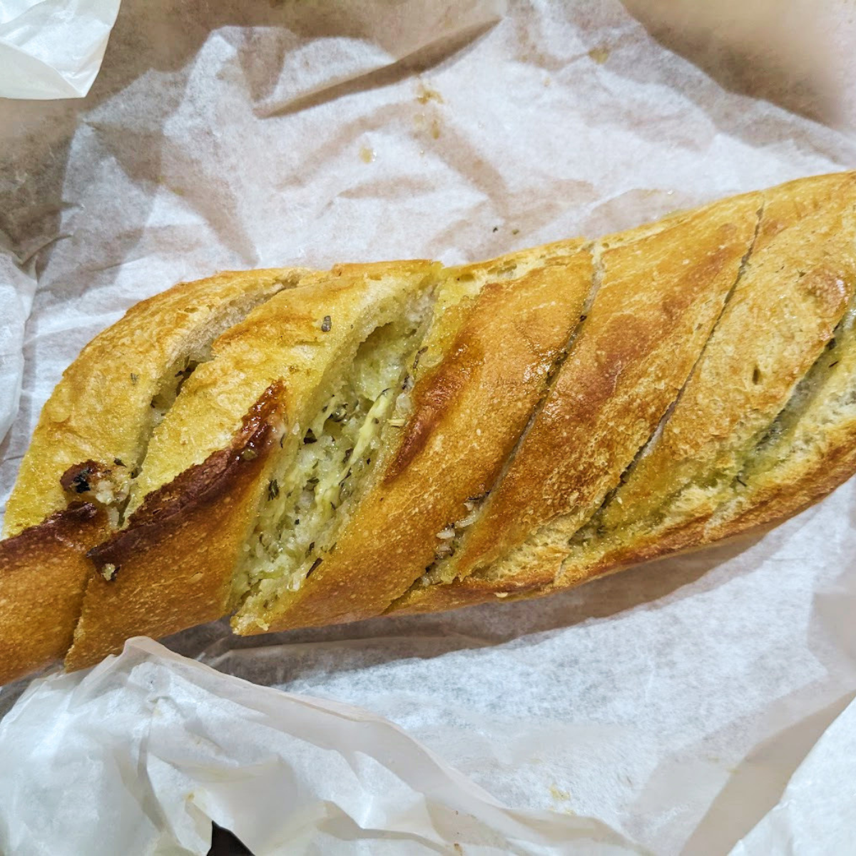 A cooked and sliced garlic baguette