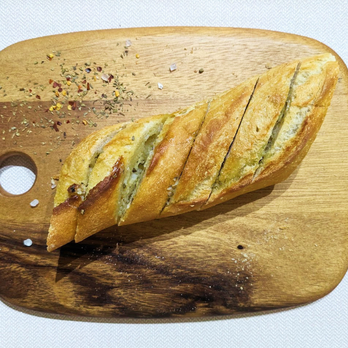 Air fryer garlic bread on a wooden chopping board