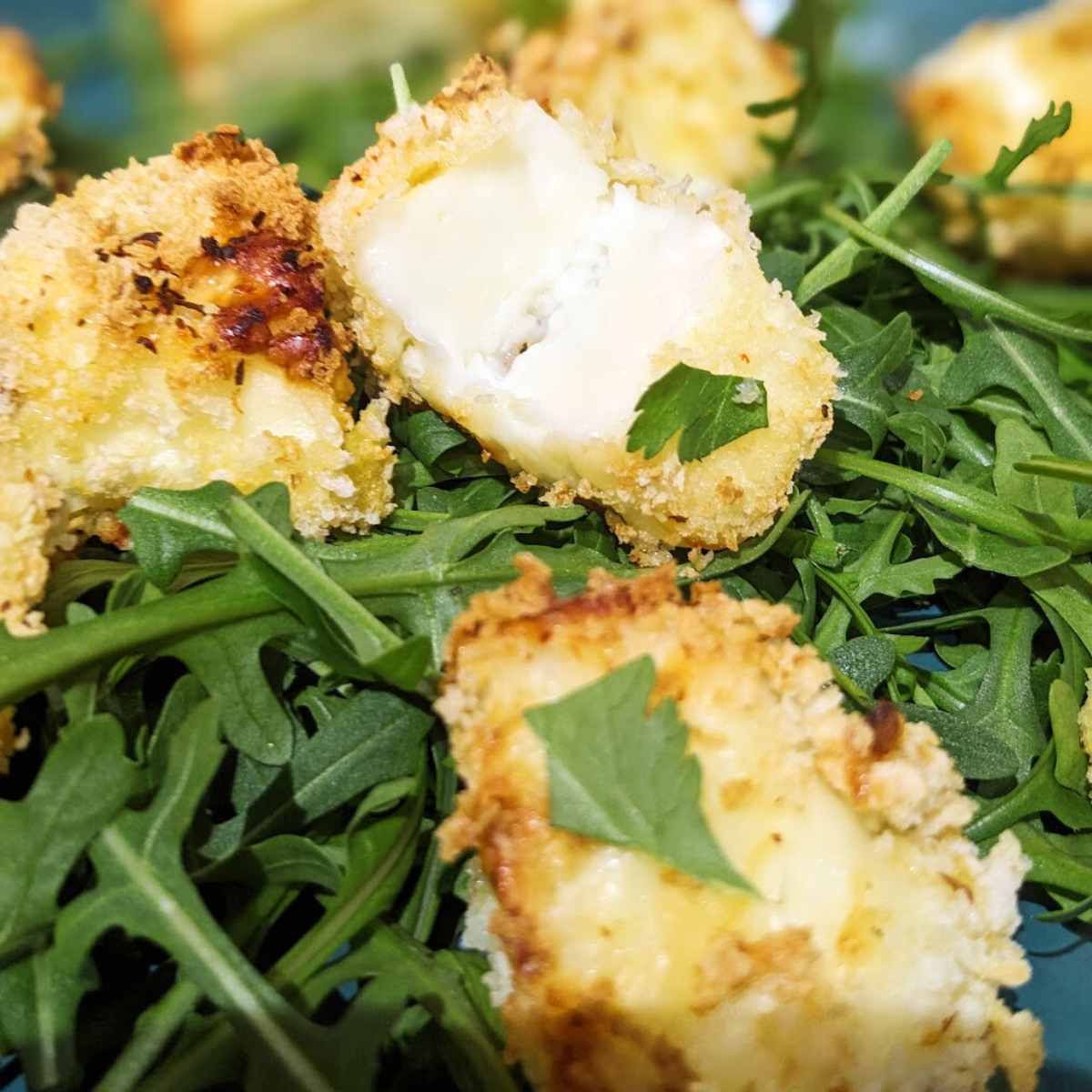 Halloumi pieces on a bed of rocket.