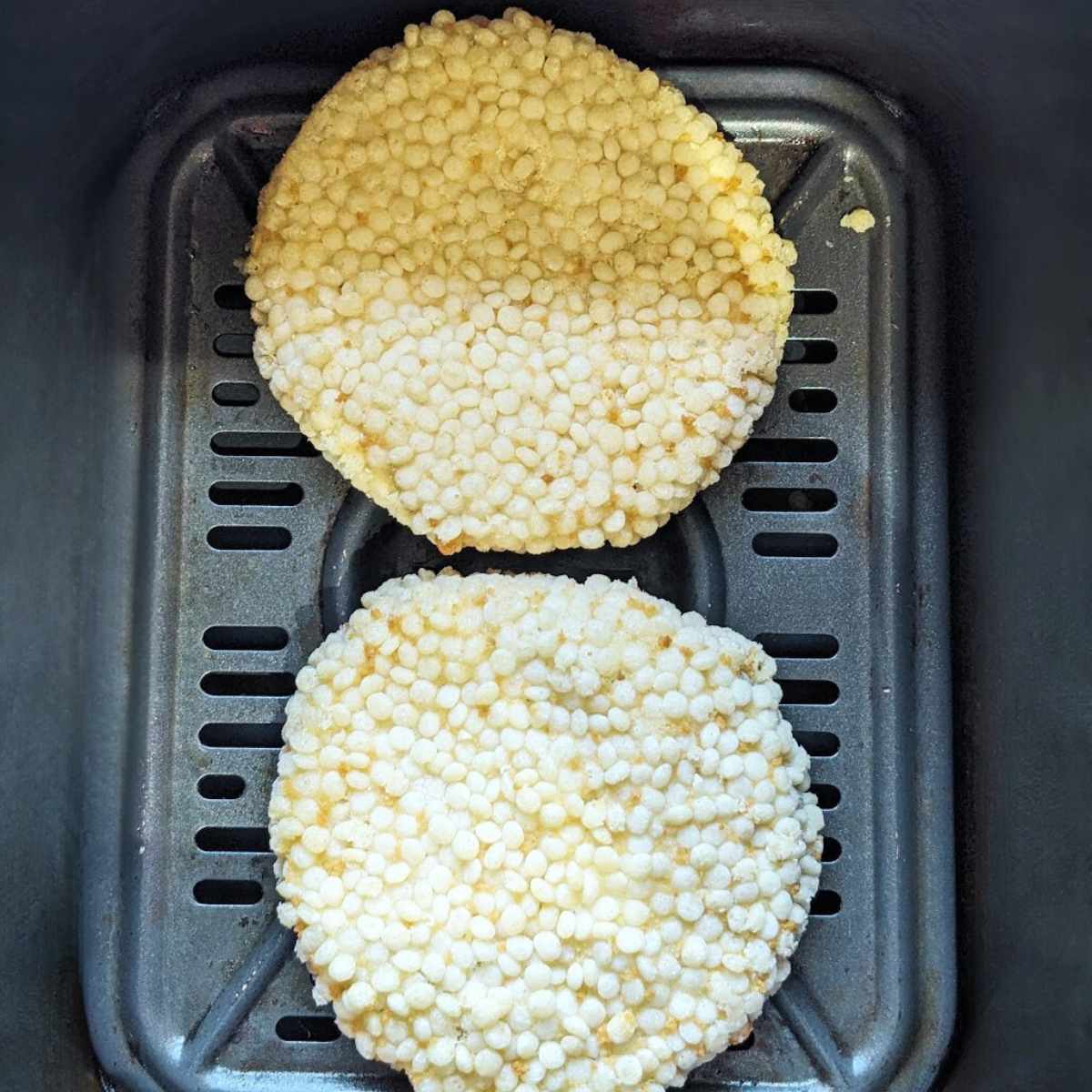 Chicken patties in an air fryer basket