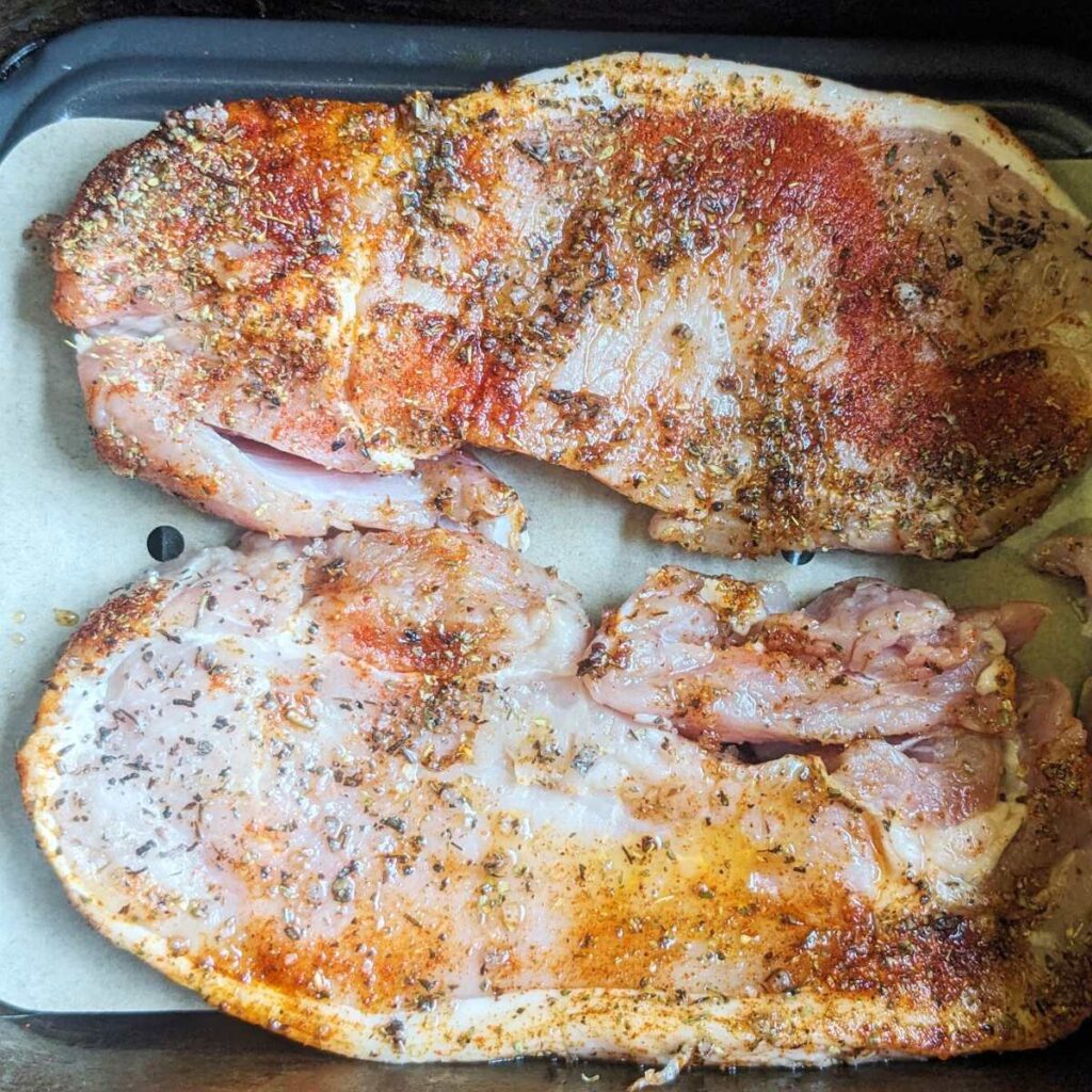 Pork chops in an air fryer drawer