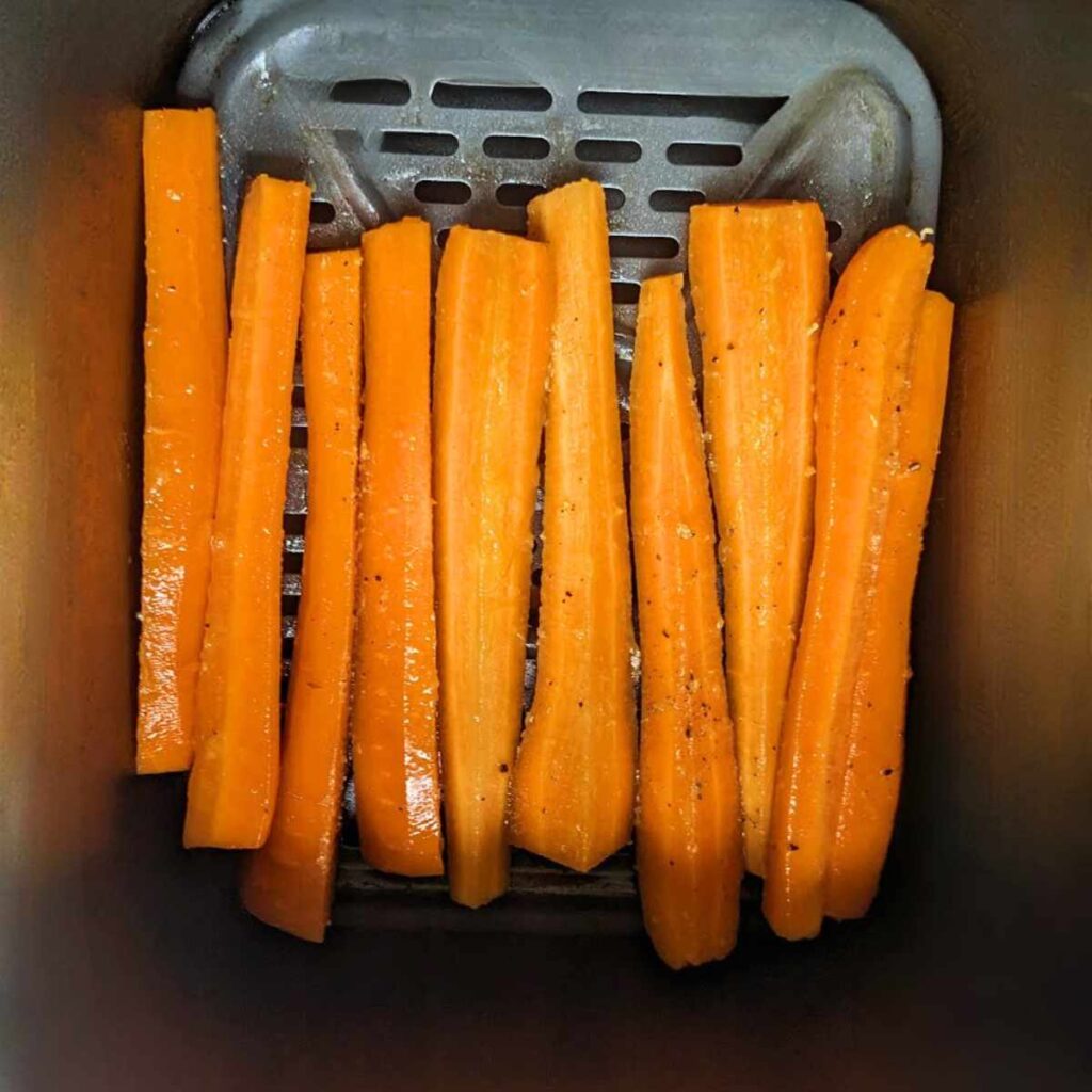 Carrot sticks in air fryer basket