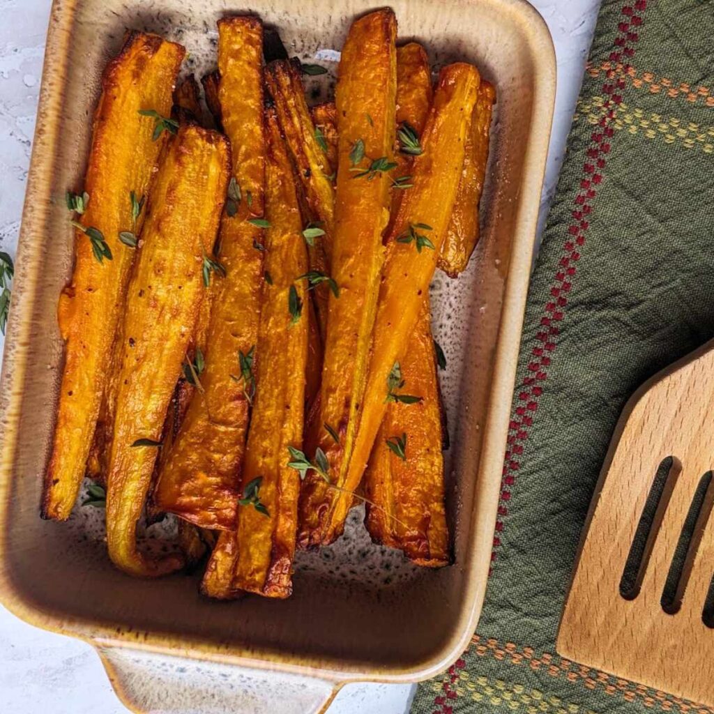 Air fryer carrots topped with herbs and served in a serving dish.
