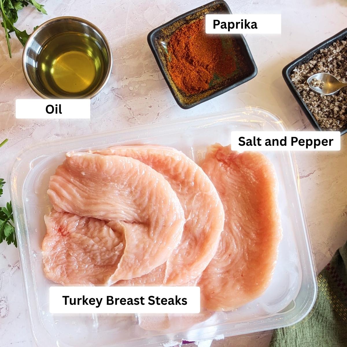 Ingredients for turkey breast steaks including turkey cutlets, paprika, oil and salt and pepper.
