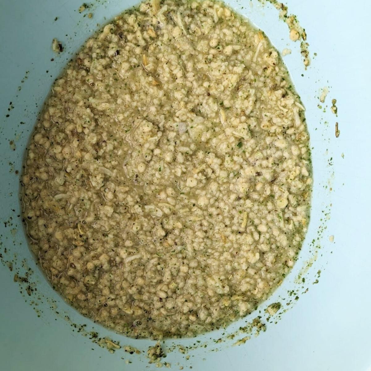 A bowl with stuffing mixture inside that has been mixed with hot water.