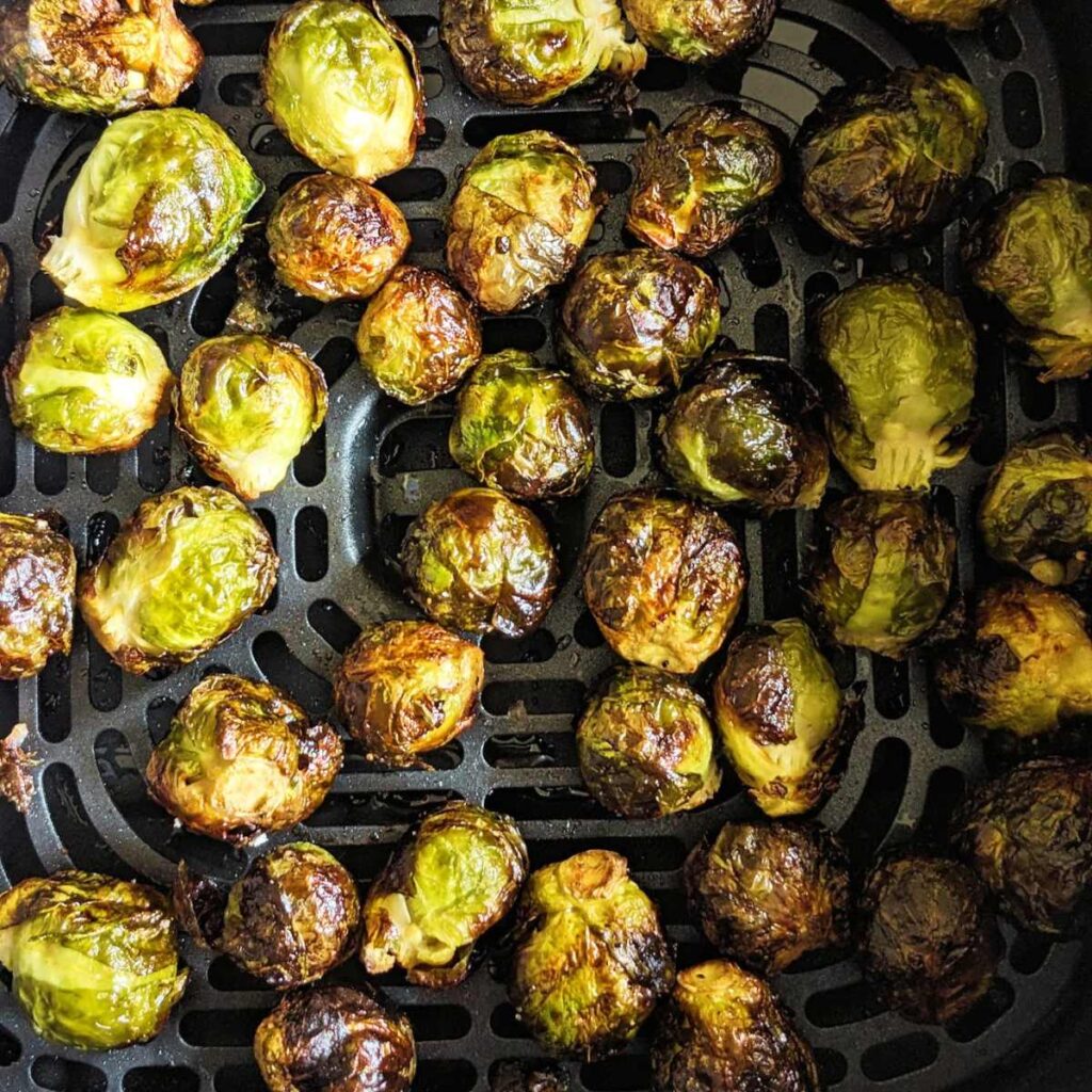 Brussels sprouts in air fryer basket.