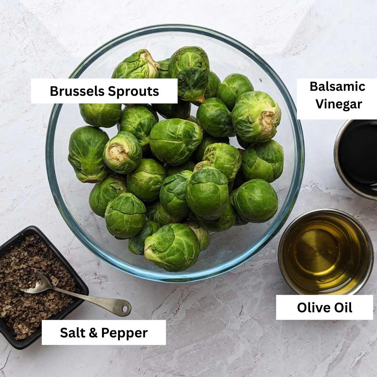 Ingredients for making Balsamic Brussels Sprouts on a kitchen worktop.