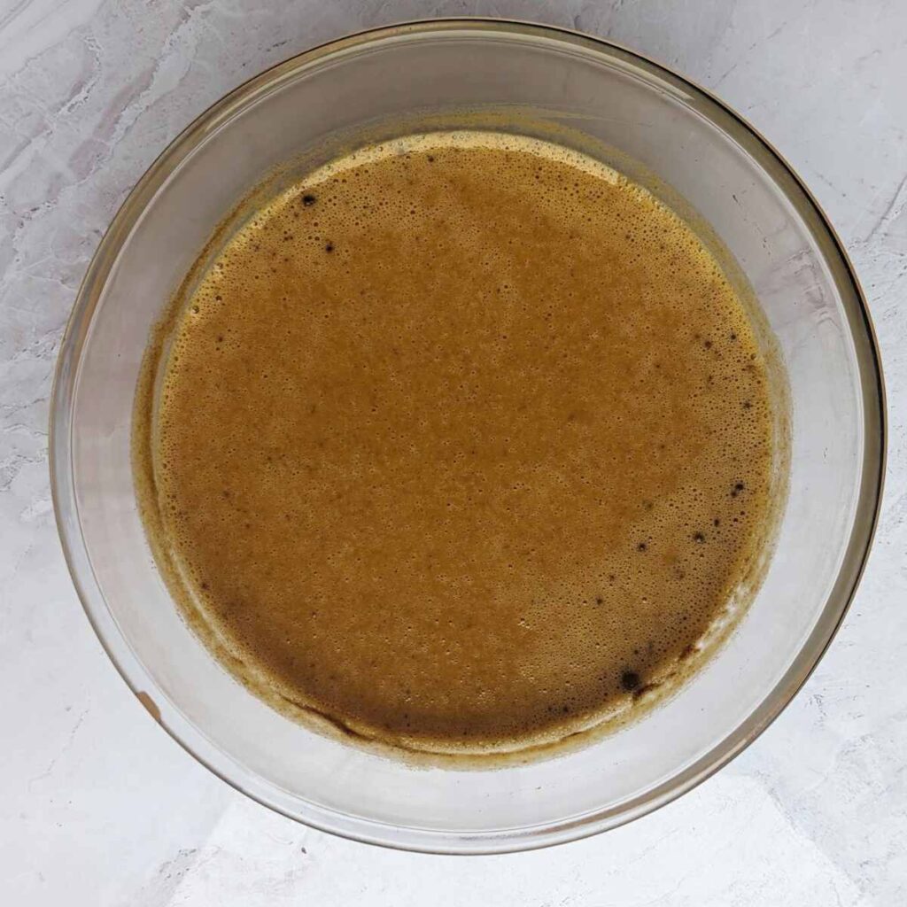 Ingredients for spicy pumpkin pie, mixed together in a glass bowl.